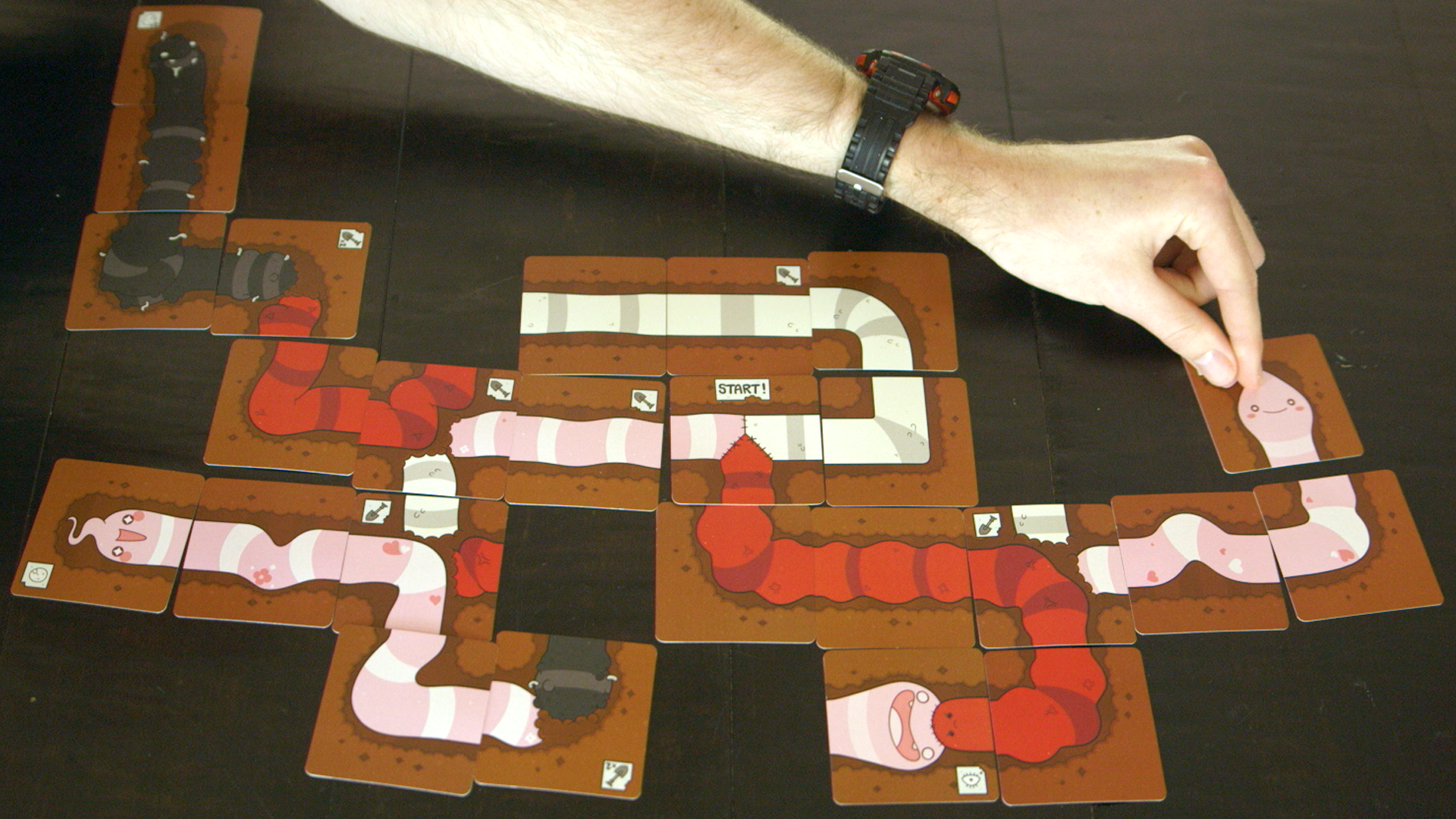 Tapeworm is a delightfully gross card game mashup of Uno and Snake